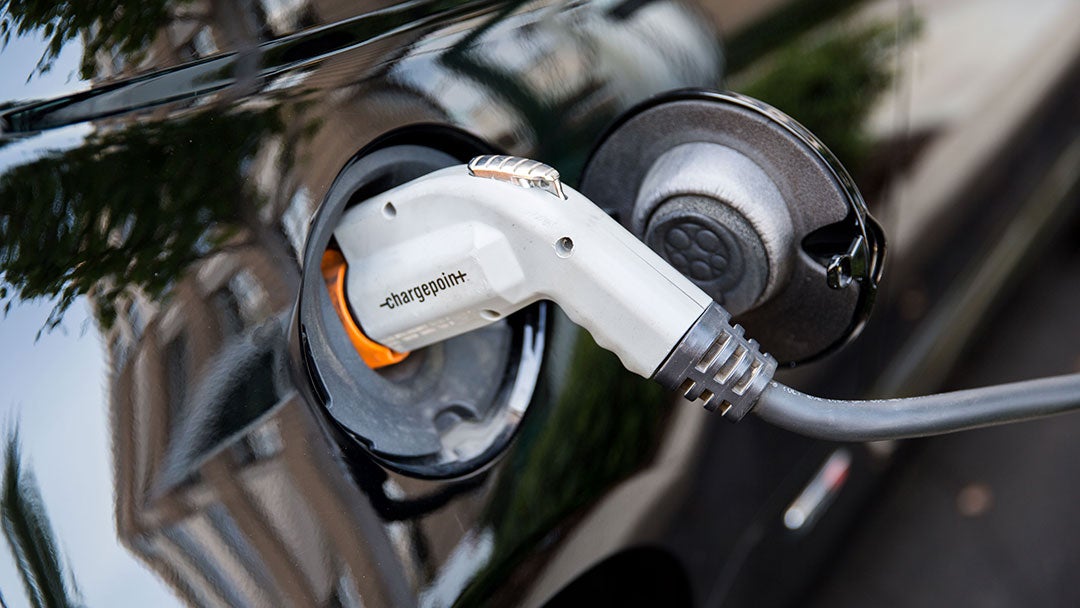 A charger plugged into an electric vehicle