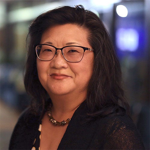 Rebecca Cheung smiles at the camera in a portrait photograph