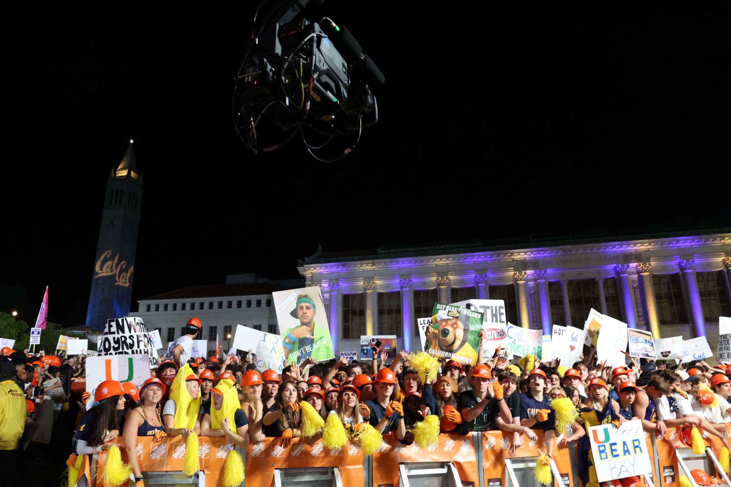 Huge crowd of Cal students in front of Doe Library, lit up in blue and gold, predawn for the College GameDay show