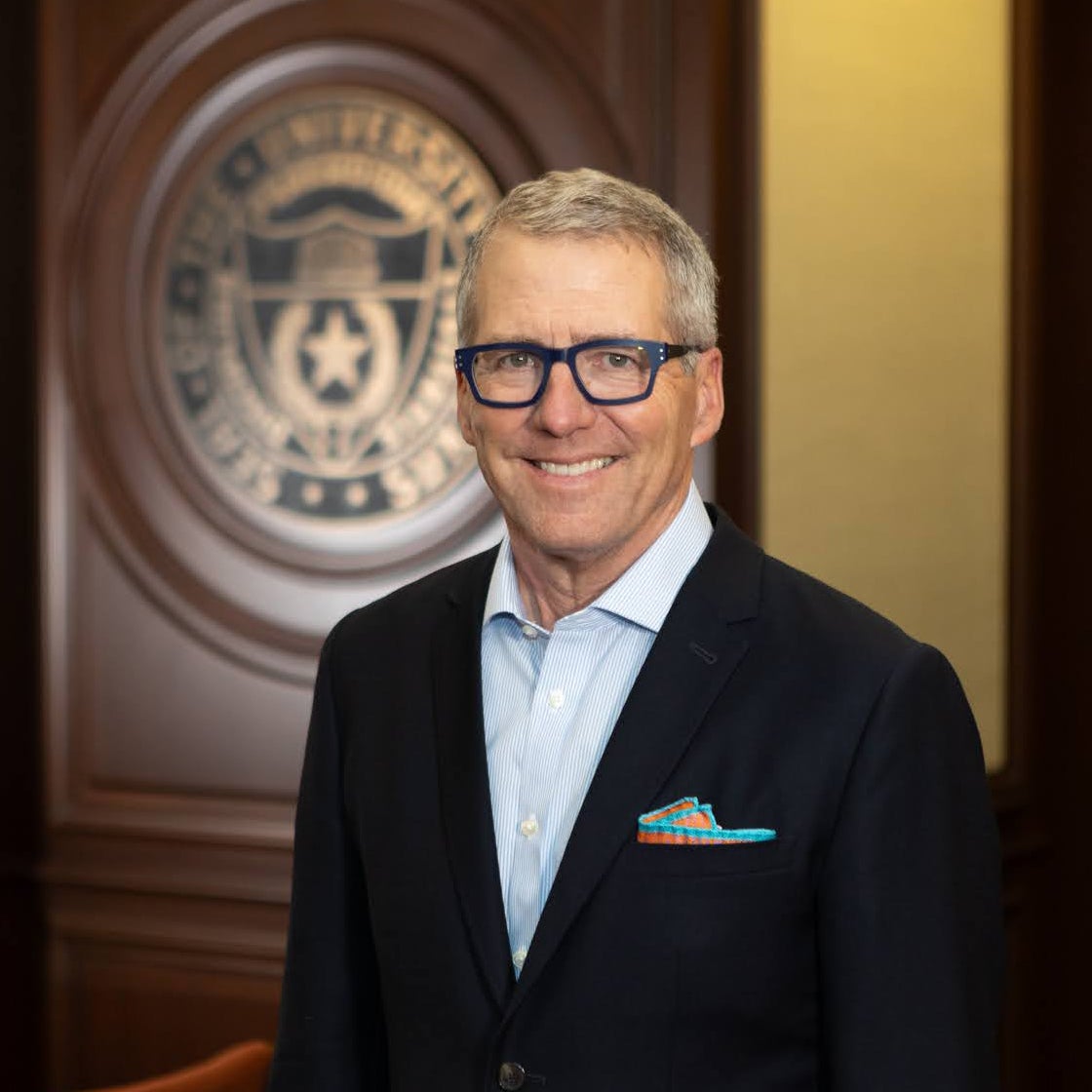 A man with glasses in a suit