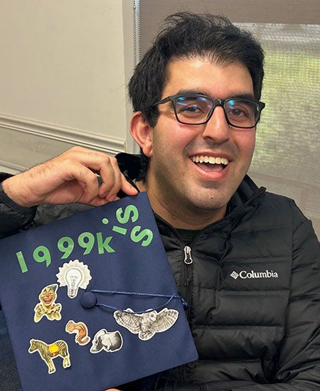 A student with a hand-decorated mortarboard