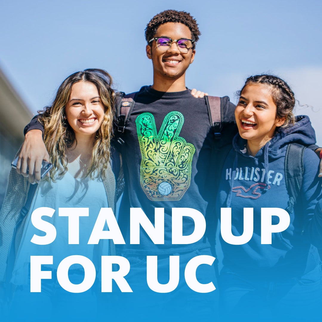 Group of three students standing with their arms around eachother with the words "Stand up for UC" on top