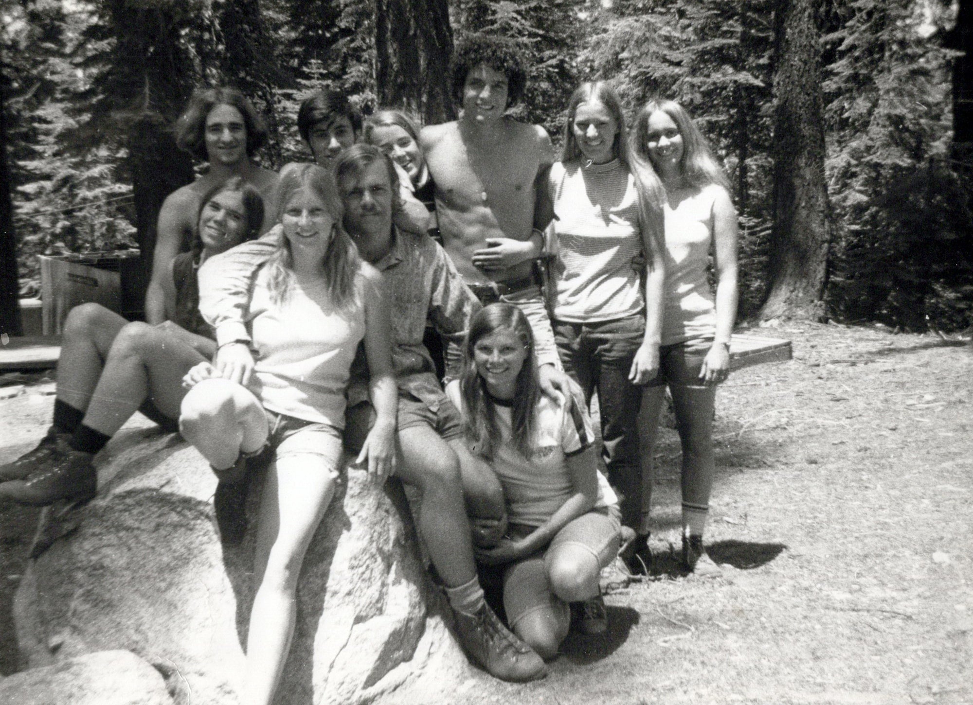 A black-and-white photo of a group of UC students in the woods