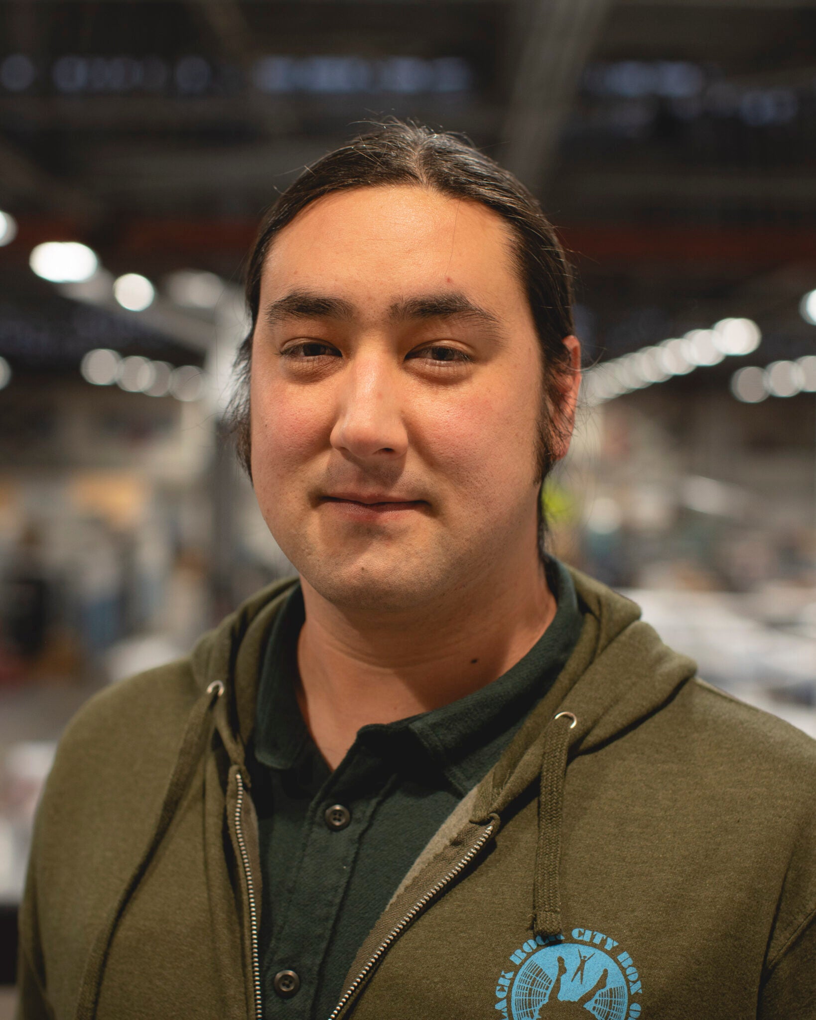 A man in an olive green sweatshirt