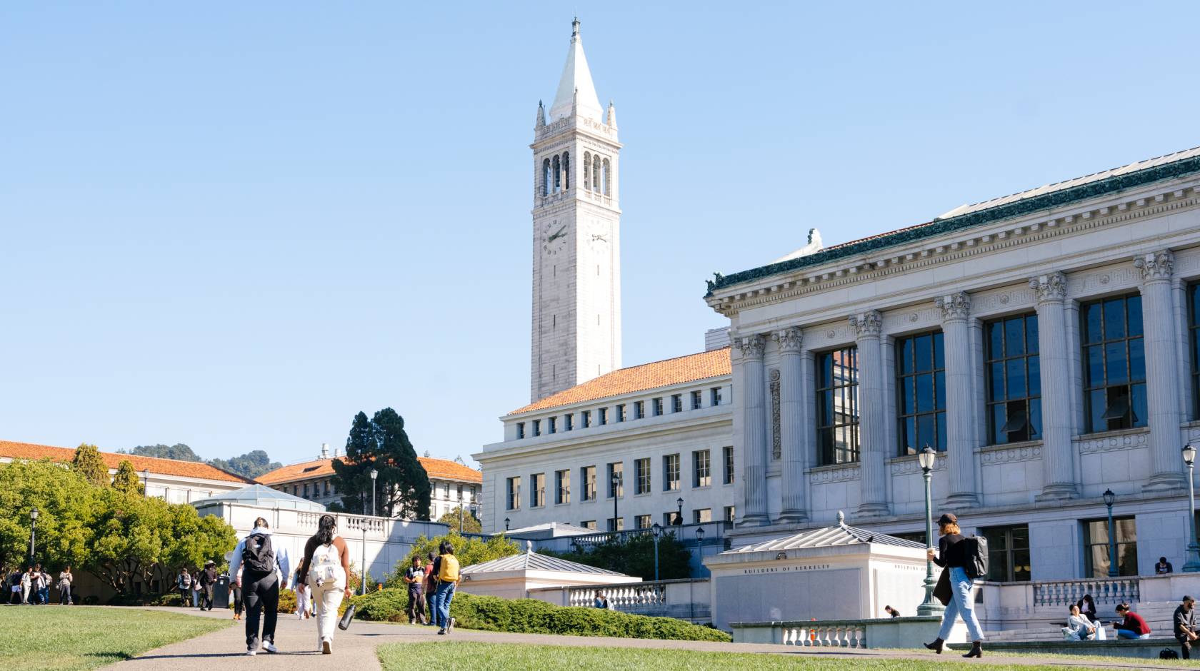 A view of the UC Berkeley campus, including Sather Tower and the library, on a day with a blue sky