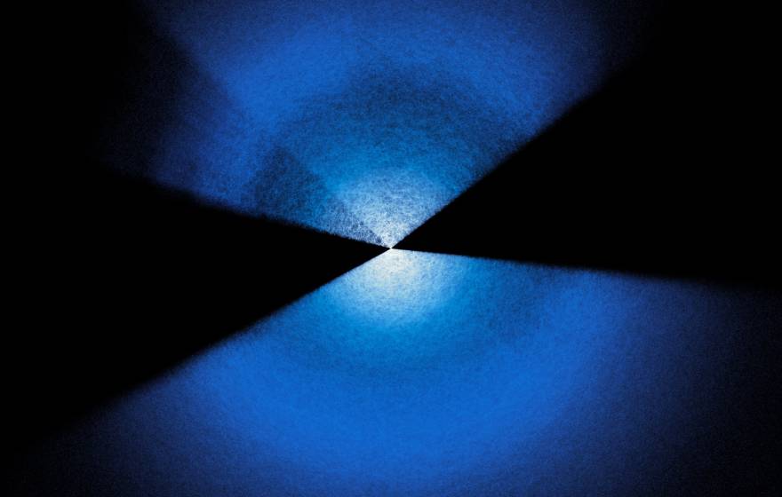 Two fans of blue and white dots extending up and down from center on black background