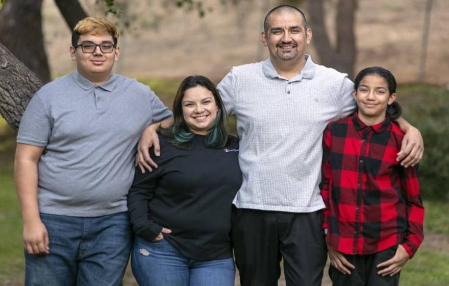 Lazaro Barajas stands with his wife, daughter and son  