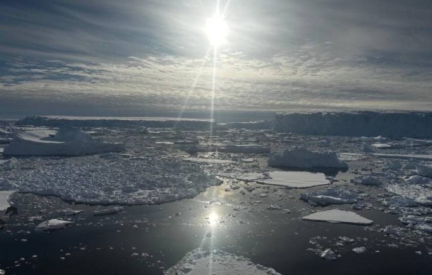 The sun glances off a sheet of ice