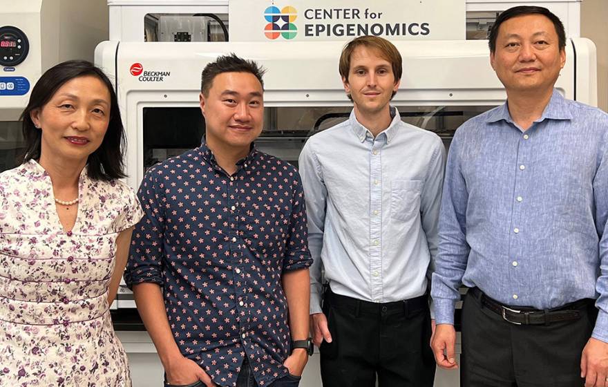 Four scientists standing together, three men one woman