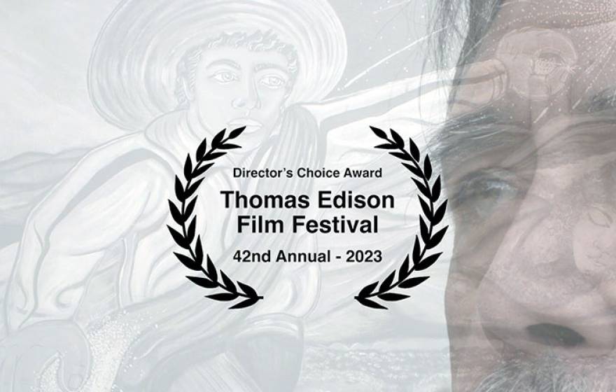 The director's choice award laurels for professor Yehuda Sharim's film "El Ojo," with its subject, Ruben Sanchez, in the background.