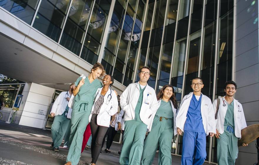 University of California Health students leaving a building together in scrubs