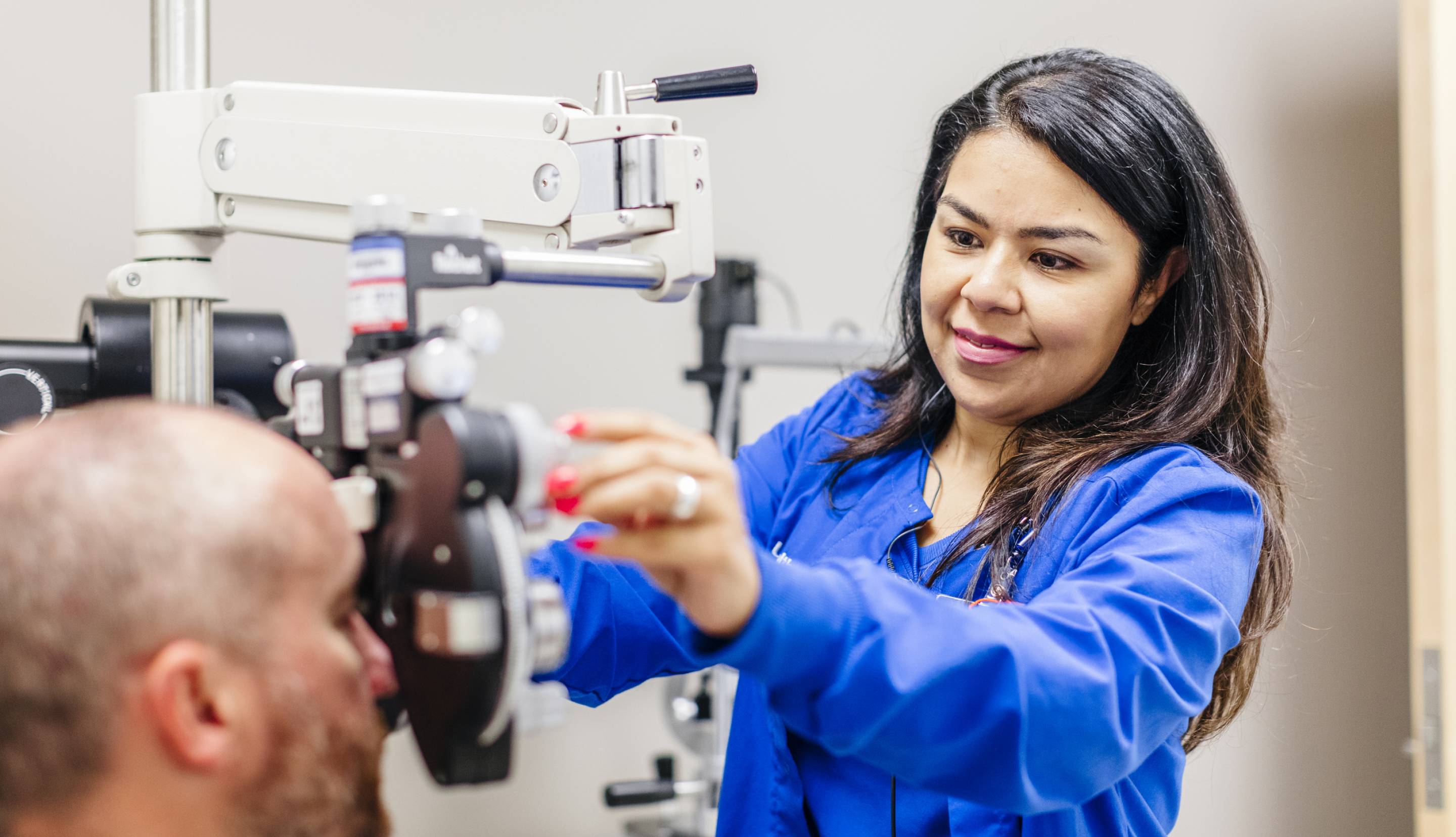 Nurse doing an eye exam on a patient