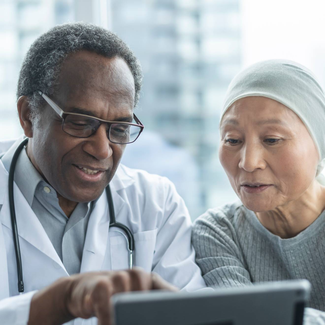 A doctor and a patient look at a screen together